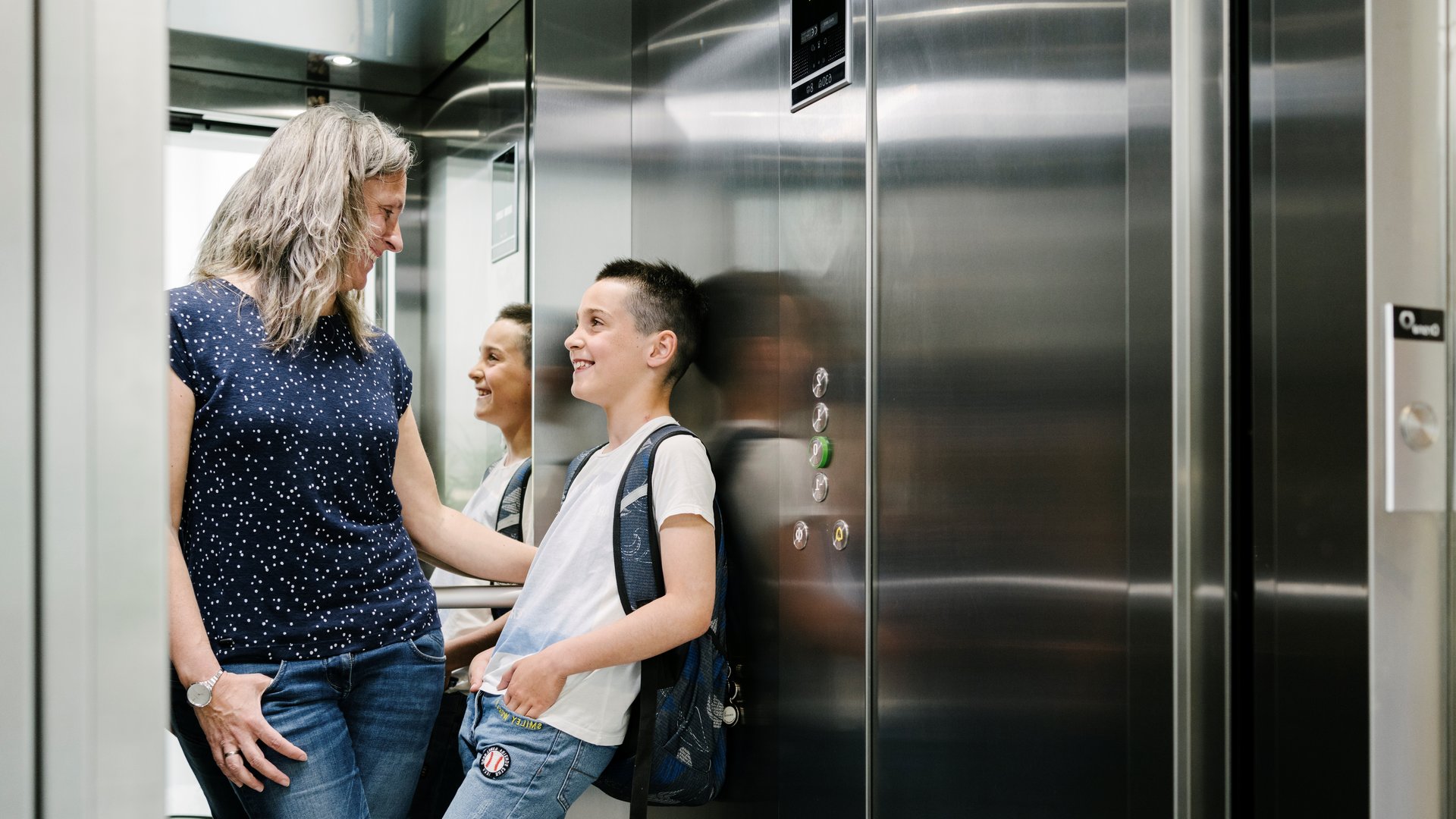 Moeder en kind in een Orona-lift