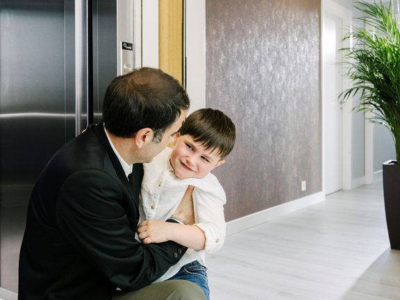 A father and his son meet at the main entrance when they get home